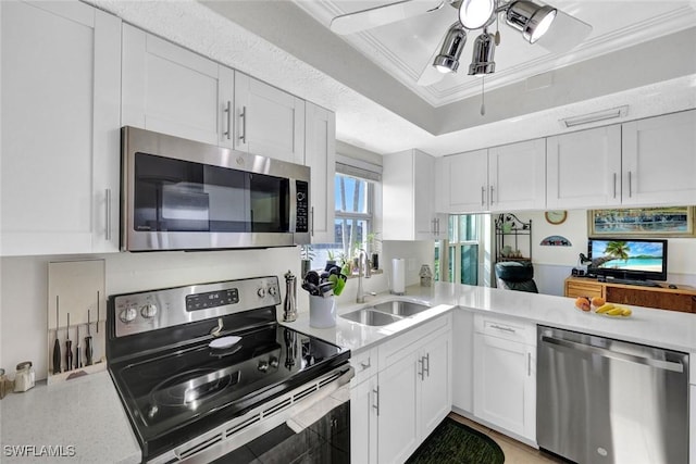 1829 SE 41st St Unit 1I, Cape Coral, FL 33904 - kitchen featuring appliances with stainless steel finishes, a sink, a ceiling fan, light countertops, and white cabinets