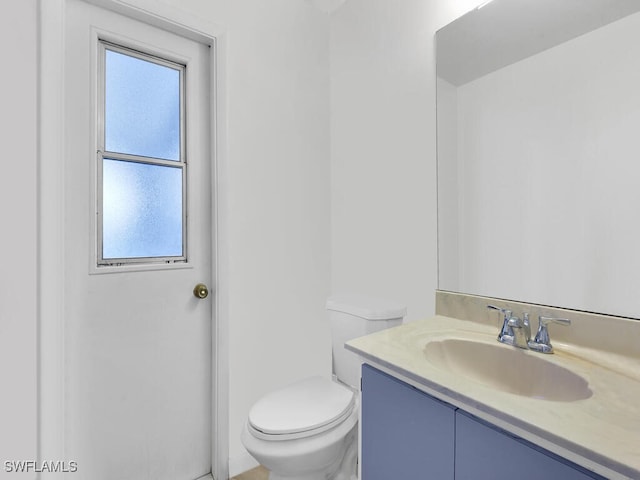 333 SE 33rd Ter, Cape Coral, FL 33904 - half bath featuring vanity, toilet, and healthy amount of natural light