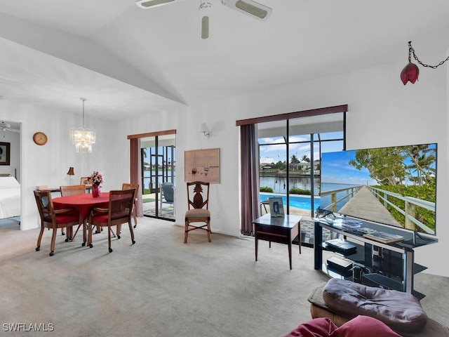 333 SE 33rd Ter, Cape Coral, FL 33904 - living room featuring carpet flooring, a ceiling fan, and a chandelier