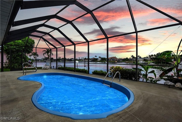 333 SE 33rd Ter, Cape Coral, FL 33904 - pool at dusk featuring a water view, an outdoor pool, a patio area, and glass enclosure