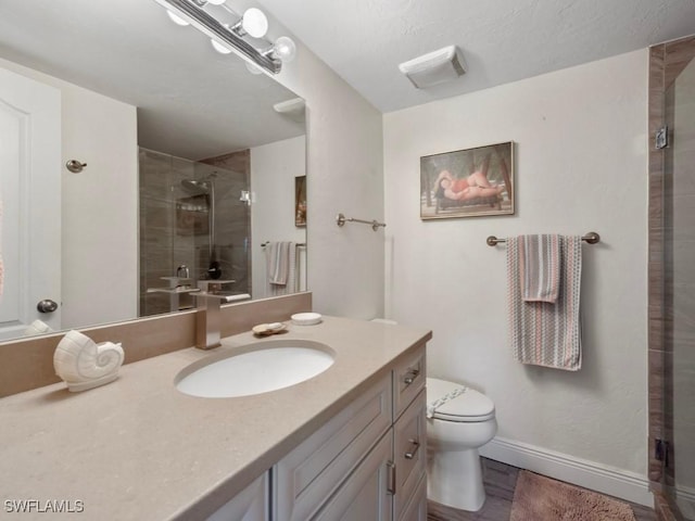 207 S Collier Blvd Unit 4-105, Marco Island, FL 34145 - bathroom featuring a stall shower, toilet, vanity, and baseboards
