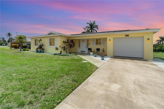 1751 Lakeview Blvd, North Fort Myers, FL 33903 - ranch-style home featuring stucco siding, a front lawn, concrete driveway, and a garage