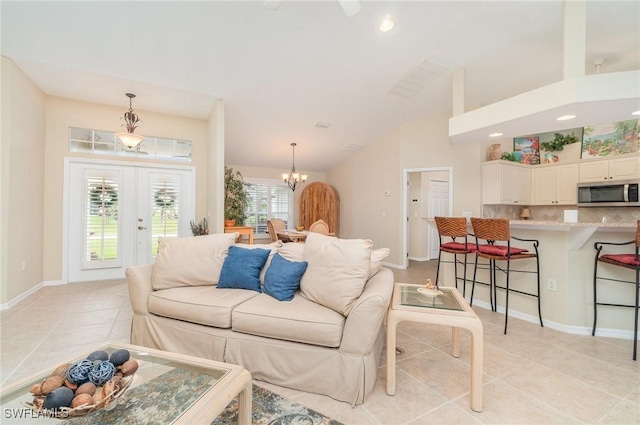 3708 SW 2nd Ln, Cape Coral, FL 33991 - living room with light tile patterned floors, vaulted ceiling, a chandelier, recessed lighting, and french doors