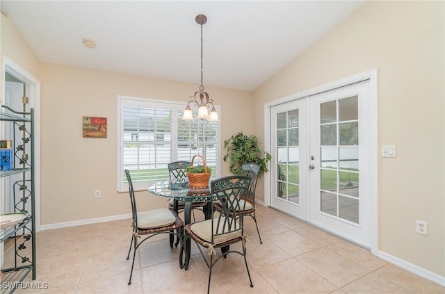 3708 SW 2nd Ln, Cape Coral, FL 33991 - dining space with french doors, vaulted ceiling, light tile patterned floors, baseboards, and a chandelier