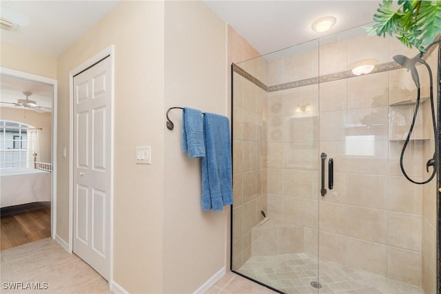3708 SW 2nd Ln, Cape Coral, FL 33991 - ensuite bathroom featuring a shower stall, baseboards, tile patterned flooring, and a ceiling fan