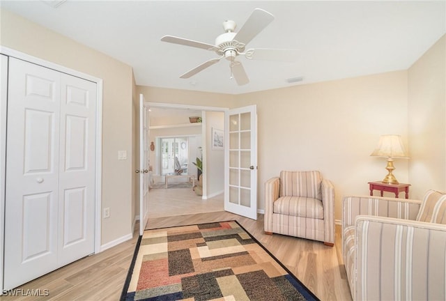 3708 SW 2nd Ln, Cape Coral, FL 33991 - bedroom with french doors, light wood-type flooring, baseboards, ceiling fan, and a closet