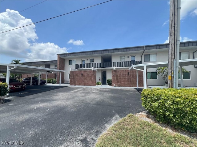 632 Victoria Dr Unit 103, Cape Coral, FL 33904 - view of front of house with covered parking and stucco siding