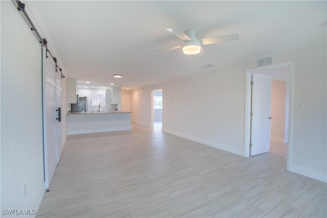 632 Victoria Dr Unit 103, Cape Coral, FL 33904 - unfurnished living room featuring a ceiling fan, baseboards, a barn door, light wood-style floors, and recessed lighting