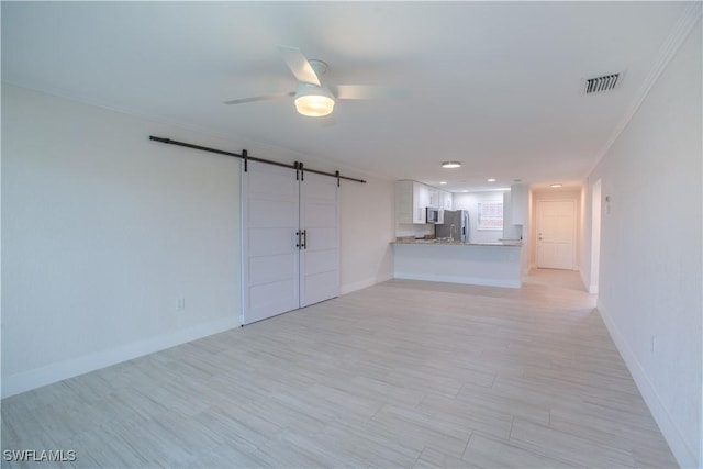 632 Victoria Dr Unit 103, Cape Coral, FL 33904 - unfurnished living room with a barn door, ceiling fan, baseboards, light wood-style flooring, and recessed lighting