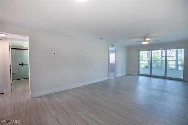 632 Victoria Dr Unit 103, Cape Coral, FL 33904 - empty room featuring a ceiling fan, baseboards, wood tiled floors, and crown molding