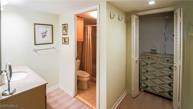 67 Pebble Beach Blvd, Naples, FL 34113 - bathroom with toilet, vanity, a shower with shower curtain, wood finished floors, and recessed lighting