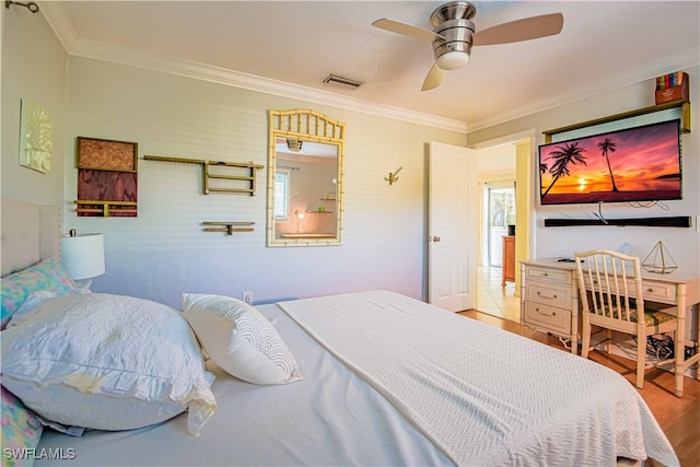 67 Pebble Beach Blvd, Naples, FL 34113 - bedroom with ornamental molding, wood finished floors, and a ceiling fan