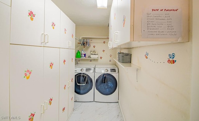 67 Pebble Beach Blvd, Naples, FL 34113 - laundry area with cabinet space, washer and clothes dryer, and light marble finish flooring