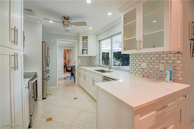 67 Pebble Beach Blvd, Naples, FL 34113 - kitchen with ceiling fan, appliances with stainless steel finishes, tasteful backsplash, crown molding, and a sink
