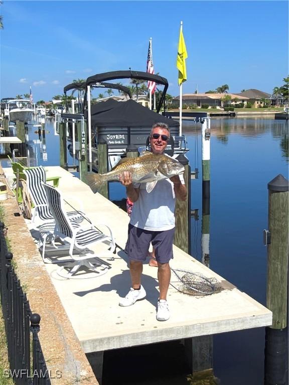 1450 Aqui Esta Dr, Punta Gorda, FL 33950 - dock with boat lift and a water view
