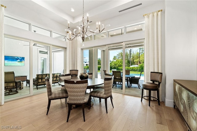 493 Myrtle Rd, Naples, FL 34108 - dining space featuring light wood-type flooring, a chandelier, recessed lighting, and a high ceiling