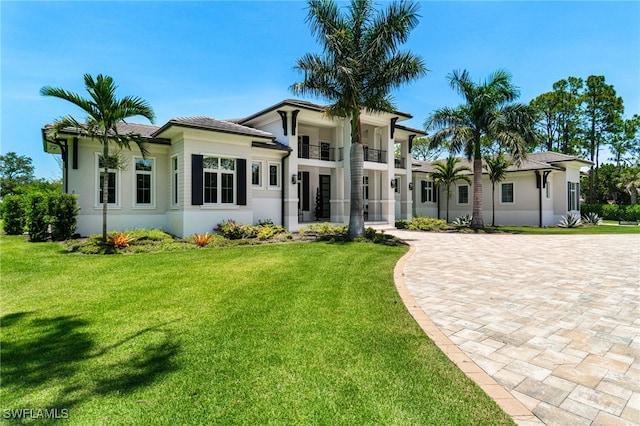493 Myrtle Rd, Naples, FL 34108 - view of front of property with a balcony, a front lawn, and stucco siding