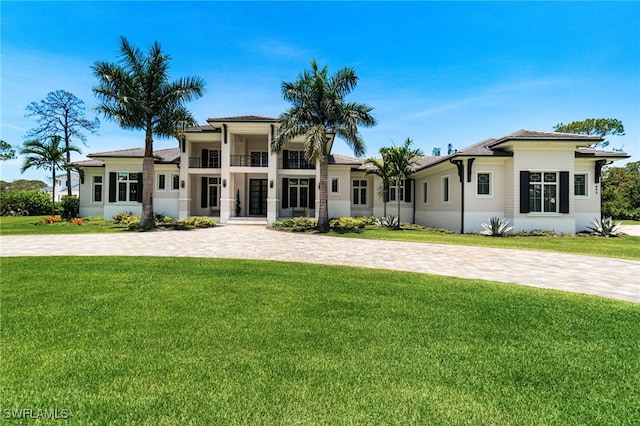 493 Myrtle Rd, Naples, FL 34108 - view of front of house with a front yard, stucco siding, and a balcony