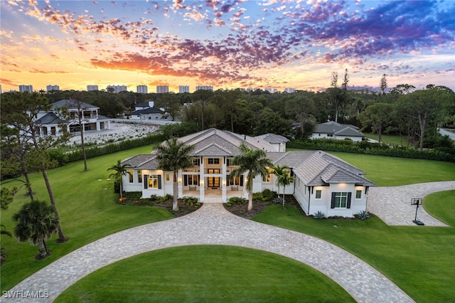 493 Myrtle Rd, Naples, FL 34108 - view of front of property with a lawn, a tile roof, and curved driveway