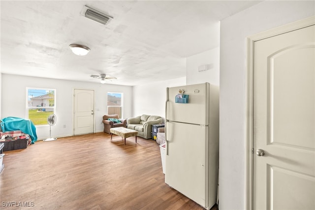 306 Wilmington Pkwy, Cape Coral, FL 33993 - kitchen featuring freestanding refrigerator, wood finished floors, a ceiling fan, and open floor plan
