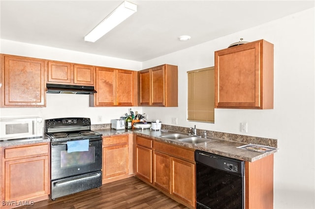 306 Wilmington Pkwy, Cape Coral, FL 33993 - kitchen with black appliances, a sink, under cabinet range hood, dark countertops, and dark wood-style flooring