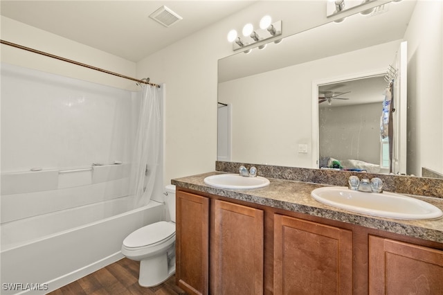 306 Wilmington Pkwy, Cape Coral, FL 33993 - full bathroom with double vanity, toilet, shower / bath combination with curtain, wood finished floors, and a ceiling fan