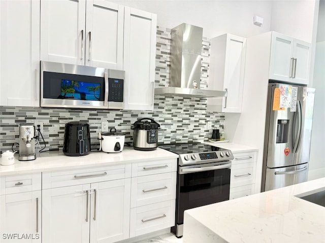 1719 NW 15th St, Cape Coral, FL 33993 - kitchen featuring appliances with stainless steel finishes, wall chimney range hood, white cabinetry, and tasteful backsplash