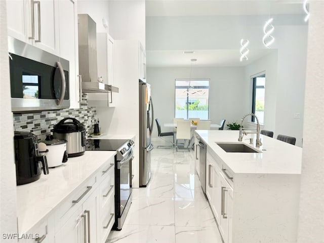 1719 NW 15th St, Cape Coral, FL 33993 - kitchen featuring stainless steel appliances, a sink, wall chimney exhaust hood, light marble finish floors, and backsplash