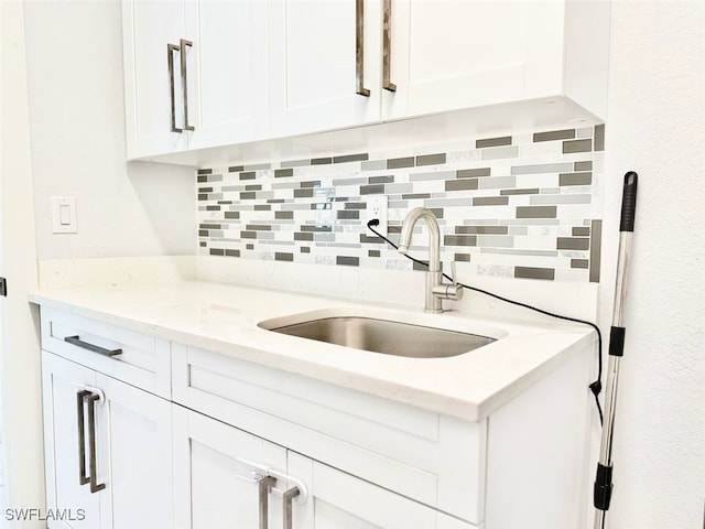 1719 NW 15th St, Cape Coral, FL 33993 - kitchen featuring a sink, tasteful backsplash, and white cabinetry
