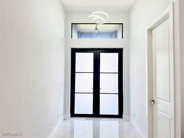 1719 NW 15th St, Cape Coral, FL 33993 - doorway featuring light marble finish floors, baseboards, and french doors