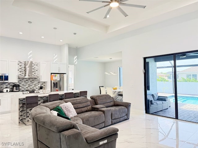 1719 NW 15th St, Cape Coral, FL 33993 - living room featuring ceiling fan, light marble finish floors, recessed lighting, and a tray ceiling