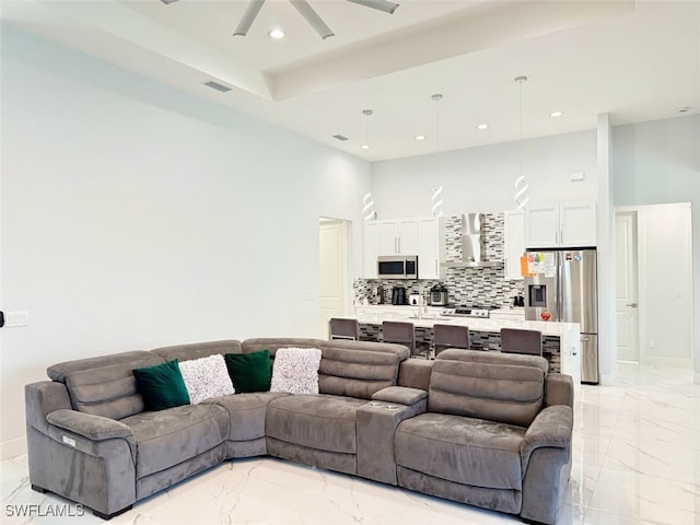 1719 NW 15th St, Cape Coral, FL 33993 - living area with light marble finish floors, a towering ceiling, a ceiling fan, recessed lighting, and baseboards