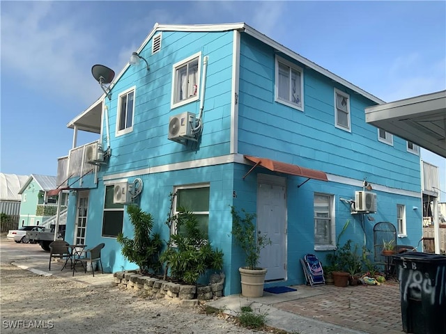 1180 Main St Unit 6, Fort Myers Beach, FL 33931 - view of front of house featuring ac unit and a patio area