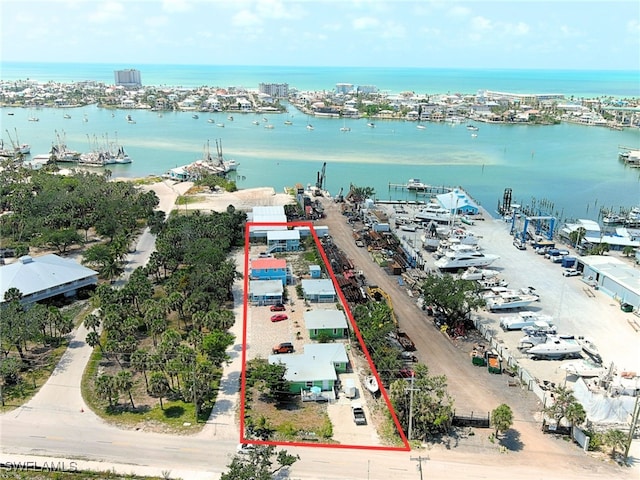 1180 Main St Unit 6, Fort Myers Beach, FL 33931 - aerial view of property and surrounding area with a large body of water, property parcel outlined, and numerous boat docks