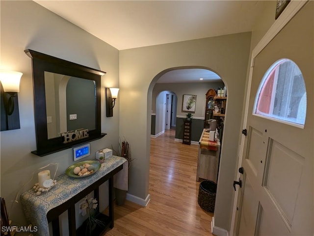11397 Argentine Ct, Bokeelia, FL 33922 - entryway with light wood-style floors, baseboards, and arched walkways