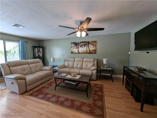 11397 Argentine Ct, Bokeelia, FL 33922 - living area with wood finished floors, ceiling fan, and baseboards