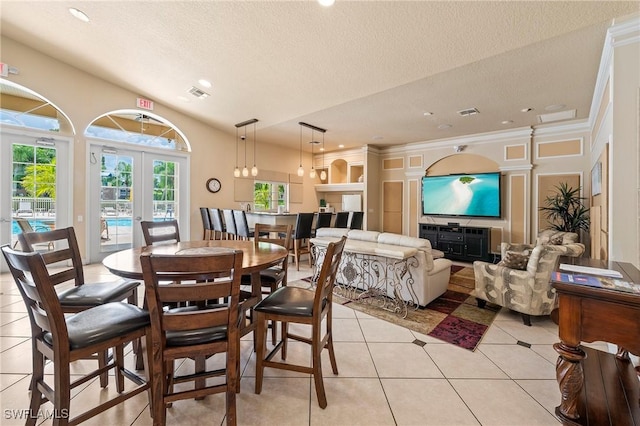 27111 Matheson Ave Unit 103, Bonita Springs, FL 34135 - dining room with light tile patterned floors, a textured ceiling, recessed lighting, and french doors