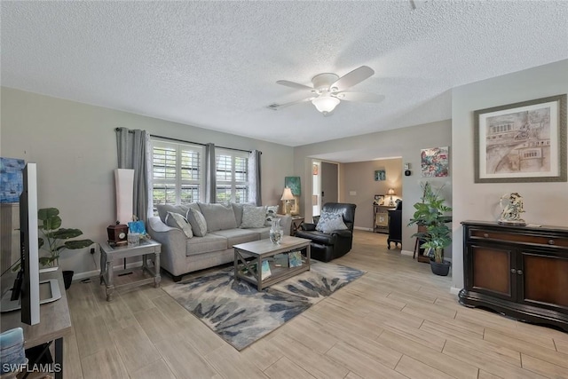 3822 Palm Tree Blvd, Cape Coral, FL 33904 - living area with a ceiling fan, light wood-style floors, baseboards, and a textured ceiling