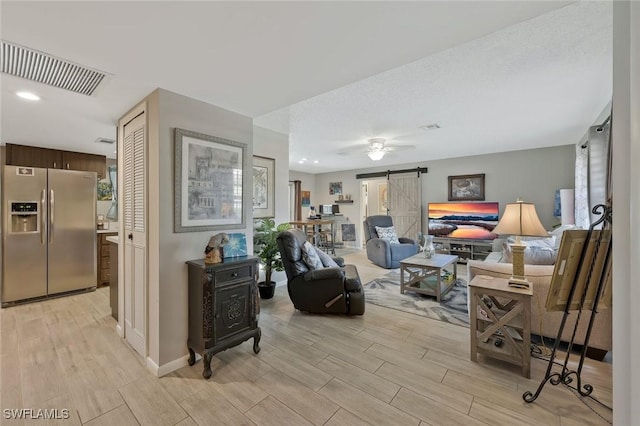 3822 Palm Tree Blvd, Cape Coral, FL 33904 - living area featuring a barn door, wood tiled floors, and baseboards