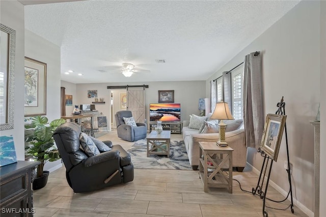 3822 Palm Tree Blvd, Cape Coral, FL 33904 - living area featuring a barn door, baseboards, a textured ceiling, and a ceiling fan