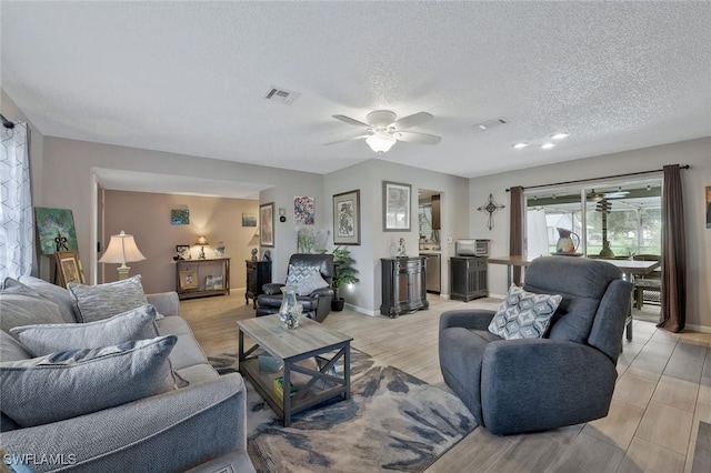 3822 Palm Tree Blvd, Cape Coral, FL 33904 - living room featuring ceiling fan, a textured ceiling, and baseboards