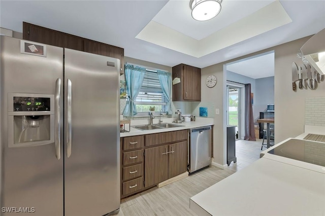 3822 Palm Tree Blvd, Cape Coral, FL 33904 - kitchen featuring stainless steel appliances, a sink, tasteful backsplash, light countertops, and a raised ceiling