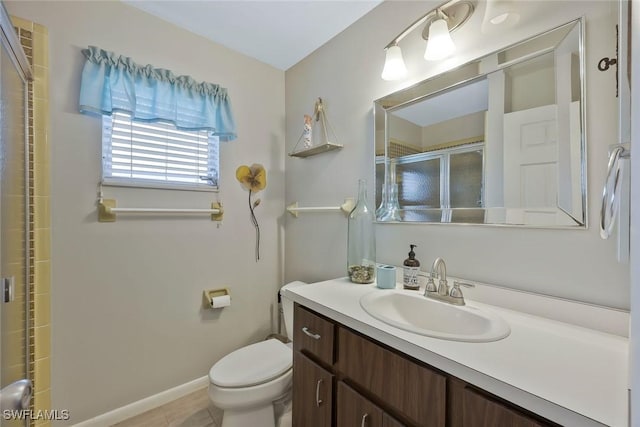 3822 Palm Tree Blvd, Cape Coral, FL 33904 - bathroom with vanity, toilet, a shower with shower door, and baseboards