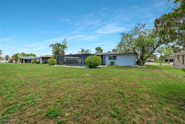 3822 Palm Tree Blvd, Cape Coral, FL 33904 - rear view of house featuring a lawn and a lanai