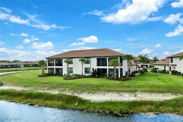 12003 Hawthorn Lake Dr Unit 101, Fort Myers, FL 33913 - back of house with a tiled roof, a water view, stucco siding, and a yard