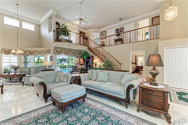 414 Caicos Dr, Punta Gorda, FL 33950 - living area with a towering ceiling, a chandelier, ornamental molding, stairway, and ceiling fan