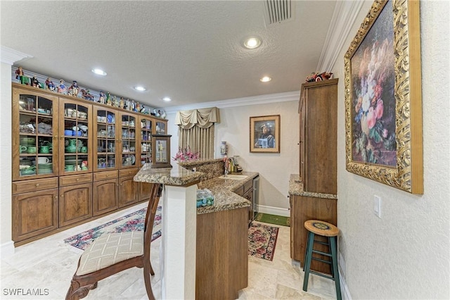 414 Caicos Dr, Punta Gorda, FL 33950 - bar area featuring crown molding, recessed lighting, baseboards, a sink, and a textured ceiling