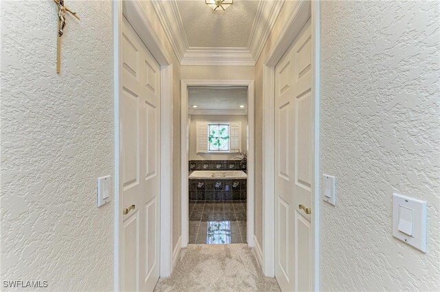 414 Caicos Dr, Punta Gorda, FL 33950 - hallway featuring a textured wall, crown molding, and carpet