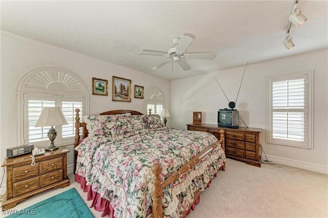 414 Caicos Dr, Punta Gorda, FL 33950 - carpeted bedroom with track lighting, ceiling fan, baseboards, and a textured ceiling