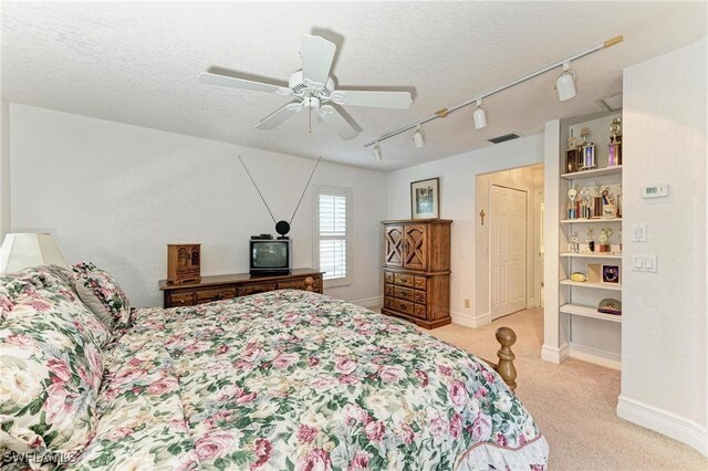 414 Caicos Dr, Punta Gorda, FL 33950 - carpeted bedroom with track lighting, a textured ceiling, ceiling fan, and baseboards
